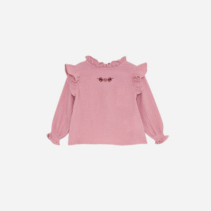 Sold at Bombon shop, this baby girl blouse by The New Society features a soft pink cotton gauze fabric, delicate ruffle details at the shoulders and cuffs, and an embroidered floral motif on the chest for a sweet, timeless look. front