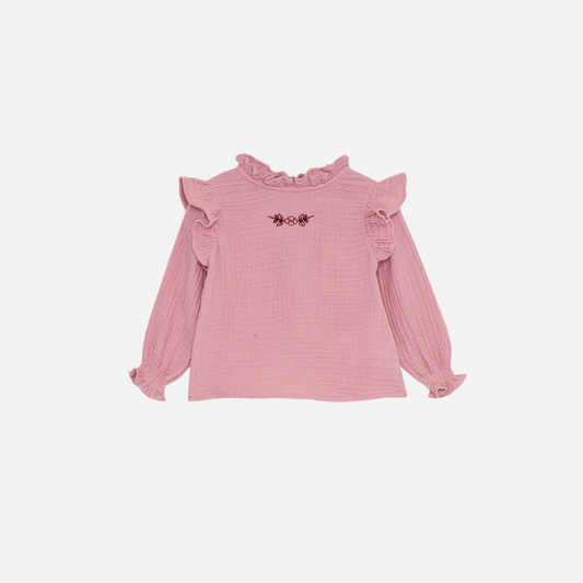 Sold at Bombon shop, this baby girl blouse by The New Society features a soft pink cotton gauze fabric, delicate ruffle details at the shoulders and cuffs, and an embroidered floral motif on the chest for a sweet, timeless look. front
