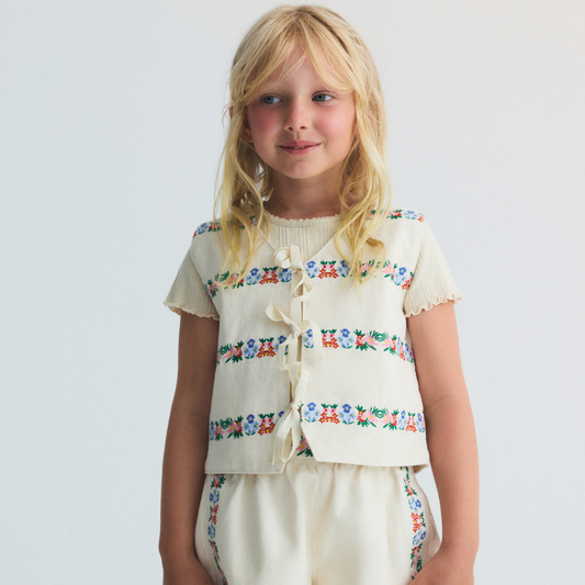sold at Bombon, designed by The New Society natural denim kids waistcoat with multicolor floral embroidery in 100% BCI cotton matching shorts set