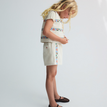 sold at Bombon, designed by The New Society natural denim kids waistcoat with multicolor floral embroidery in 100% BCI cotton matching shorts set