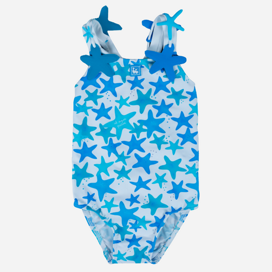 sold at Bombon shop, designed by Al Agua Patos Brand, this star print one piece bathing suit for girls in blue is perfect for summer. Front view