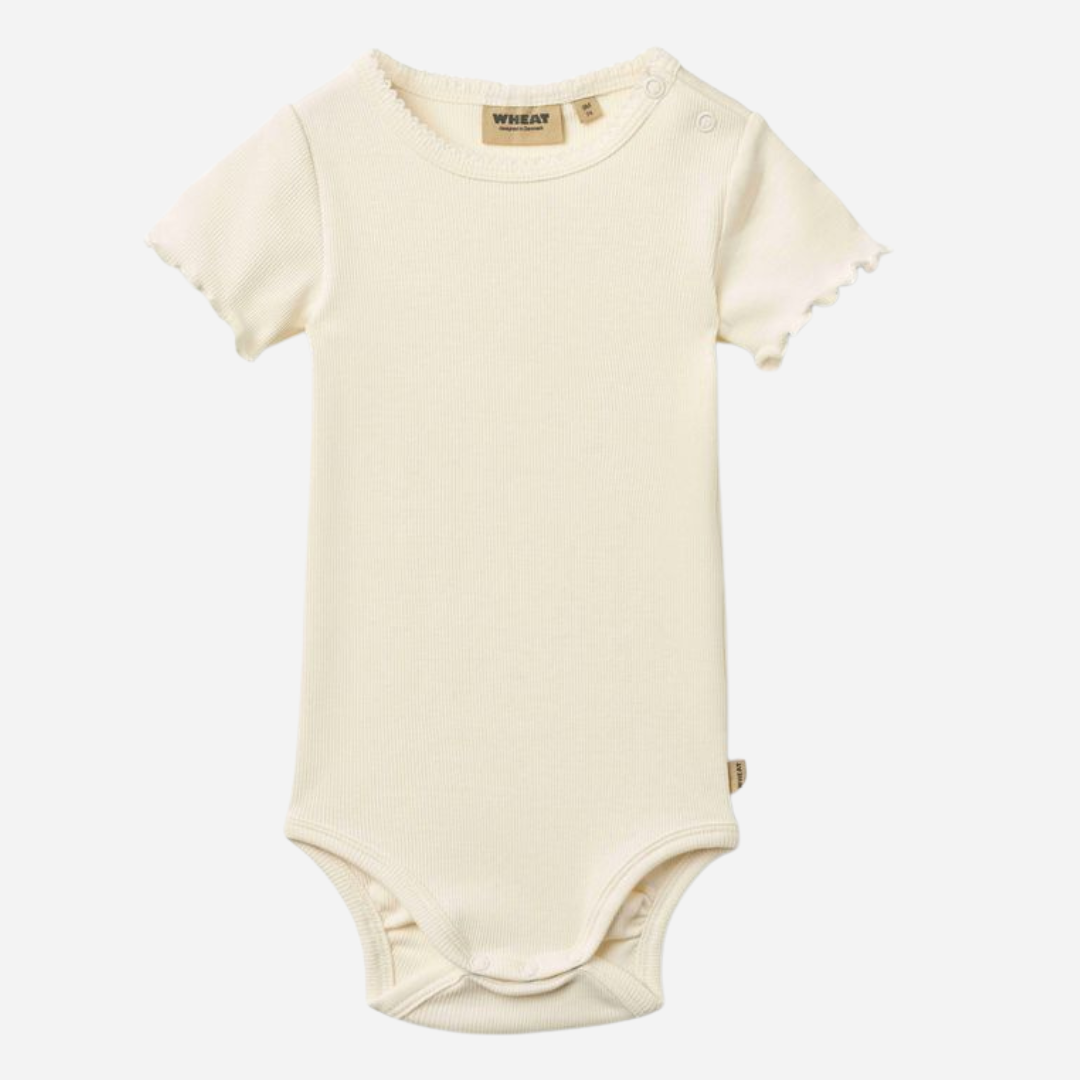Sold at Bombon Shop, designed by Wheat, ivory organic cotton short sleeve baby bodysuit with a soft minimal silhouette.