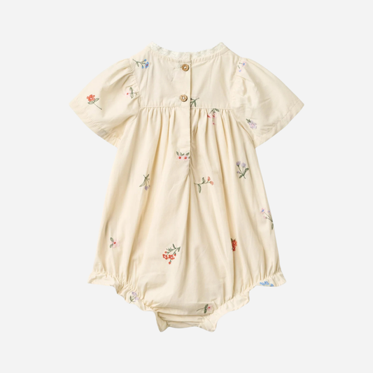 Sold at Bombon Shop, designed by Wheat, ivory organic cotton baby romper with delicate embroidered flowers and soft gathered detailing. back