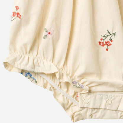 Sold at Bombon Shop, designed by Wheat, ivory organic cotton baby romper with delicate embroidered flowers and soft gathered detailing. zoom