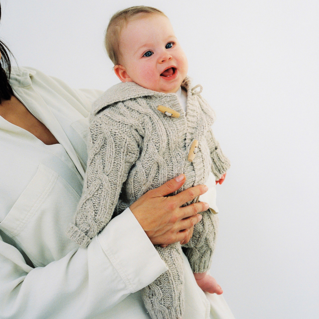 Sold at Bombon shop, these baby pants by The New Society feature a cozy cable knit texture with an elasticated waist and cuffs for a comfortable everyday fit. model