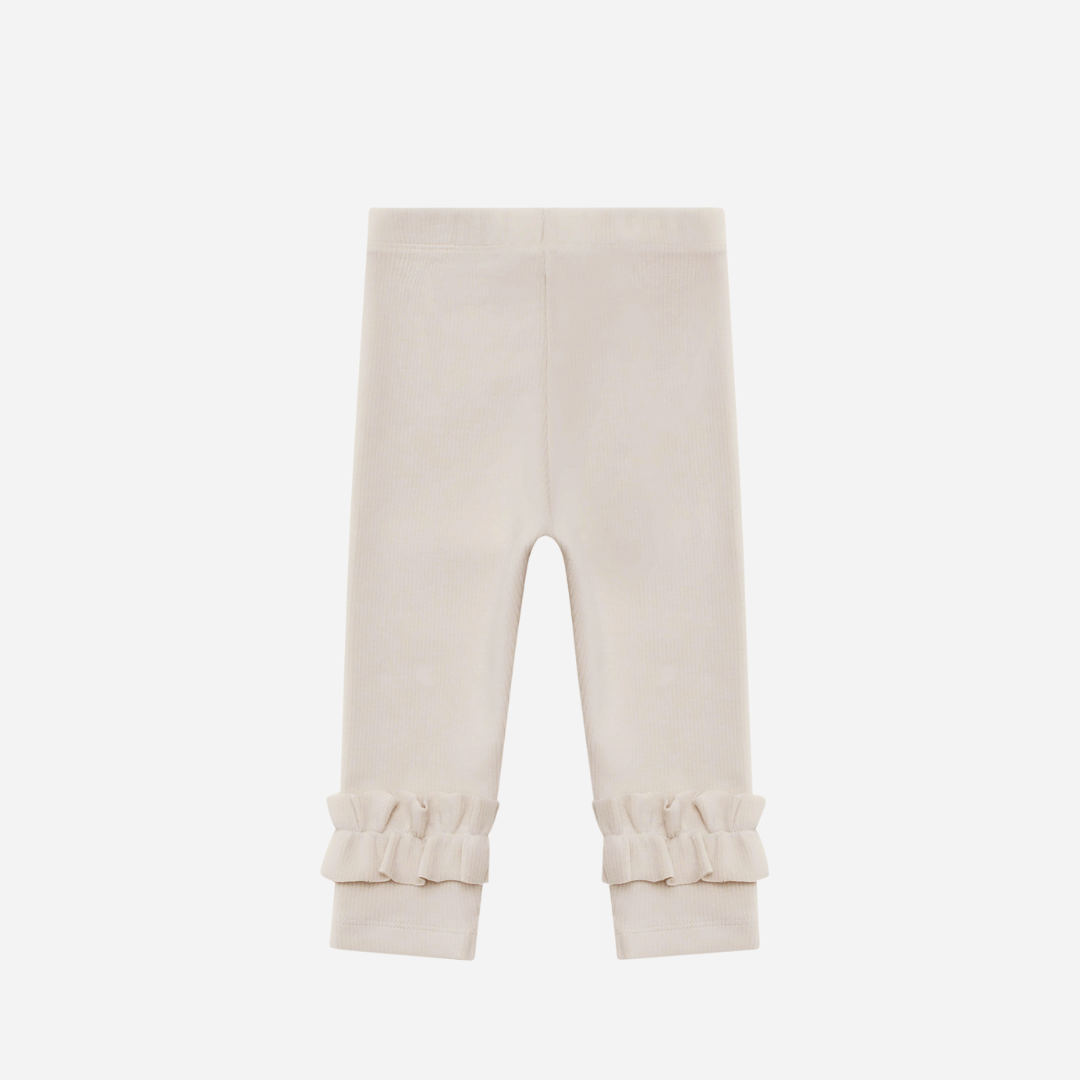 Sold at Bombon shop, designed by Donsje from Amsterdam, these leggings in a soft sand color and ruffle detail in the bottom leg for baby gris and toddler are the perfect piece for pre fall all the way through winter.  back view