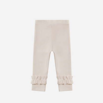 Sold at Bombon shop, designed by Donsje from Amsterdam, these leggings in a soft sand color and ruffle detail in the bottom leg for baby gris and toddler are the perfect piece for pre fall all the way through winter.  back view