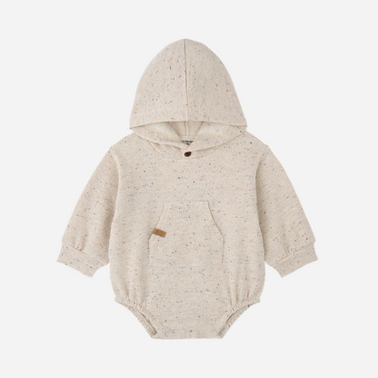 Sold at Bombon shop, designed by 1+ in the family — speckled cream baby romper with hood, long sleeves, and front kangaroo pocket.