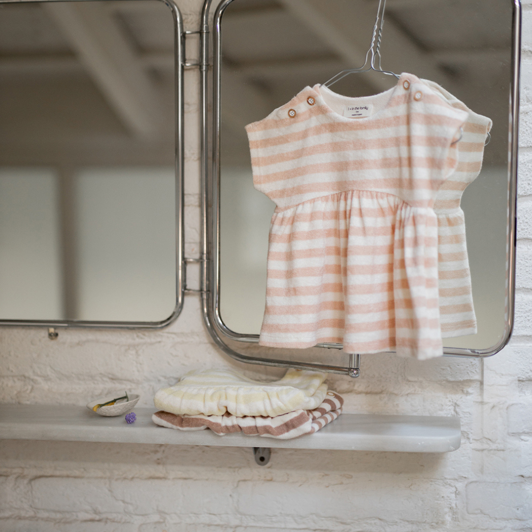 Sold at Bombon Shop, designed by 1+ in the family, blossom striped baby dress with softly gathered skirt and lightweight cotton fabric.