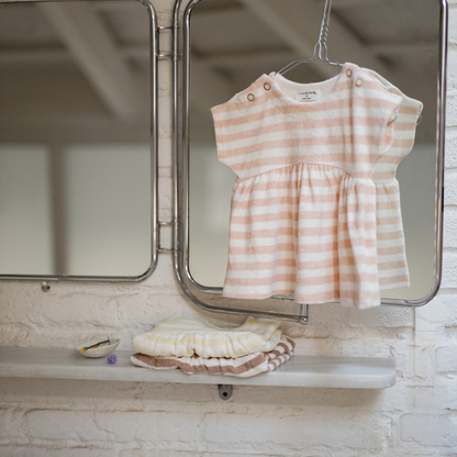 Sold at Bombon Shop, designed by 1+ in the family, blossom striped baby dress with softly gathered skirt and lightweight cotton fabric.