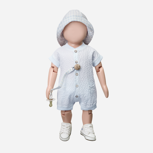Sold at Bombon Shop, designed by 1+ in the family, misty blue baby overall with front button detail and textured cotton fabric.