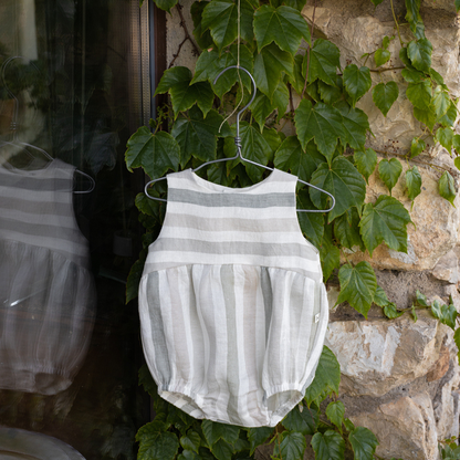 Sold at Bombon Shop, designed by 1+ in the family, beige striped baby romper with soft cotton fabric and relaxed silhouette.