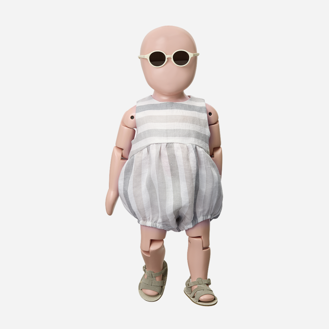 Sold at Bombon Shop, designed by 1+ in the family, beige striped baby romper with soft cotton fabric and relaxed silhouette.