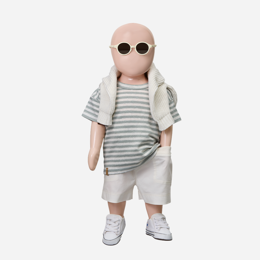 Sold at Bombon Shop, designed by 1+ in the family, off-white baby bermuda shorts with front button detail and soft cotton fabric.