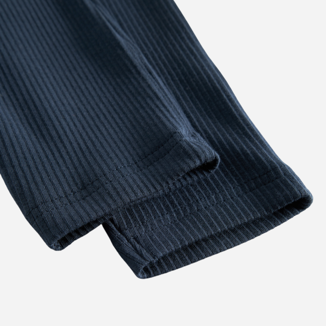 Sold at Bombon shop, designed by MarMar Copenhagen — navy ribbed organic cotton baby pants with drawstring, part of a matching set.