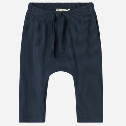 Sold at Bombon shop, designed by MarMar Copenhagen — navy ribbed organic cotton baby pants with drawstring, part of a matching set.