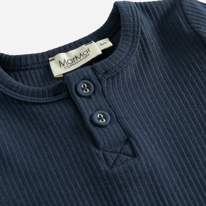 Sold at Bombon shop, designed by MarMar Copenhagen — navy ribbed organic cotton long-sleeve baby top with buttoned neckline, part of a matching set.