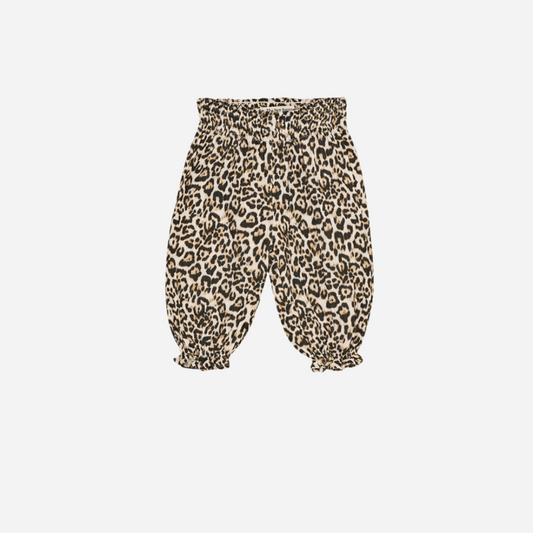 Sold at Bombon shop, designed by The New Society, these baby girl pants feature an all-over leopard print with an elastic waistband and gathered hems for a comfy, playful fit. front