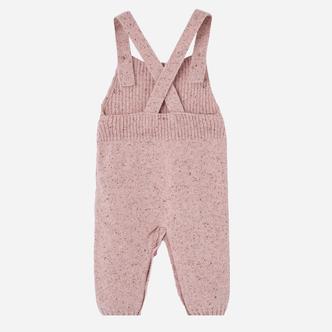 Sold at Bombon shop, designed by Paz Rodriguez. Cream floral muslin baby bodysuit with ruffle collar paired with pink knit overalls featuring front pocket and button straps.