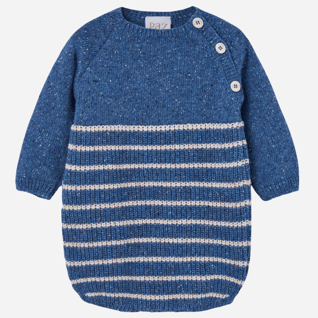 Sold at Bombon shop, designed by Paz Rodriguez, blue knit baby romper with cream horizontal stripes and shoulder buttons.