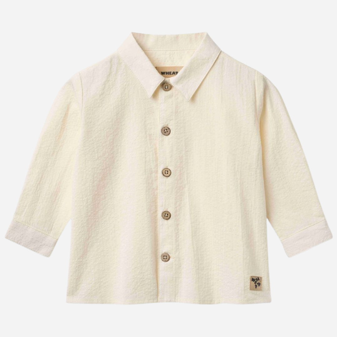 Sold at Bombon Shop, designed by Wheat, ivory organic cotton long sleeve button-down shirt with classic collar and clean silhouette.