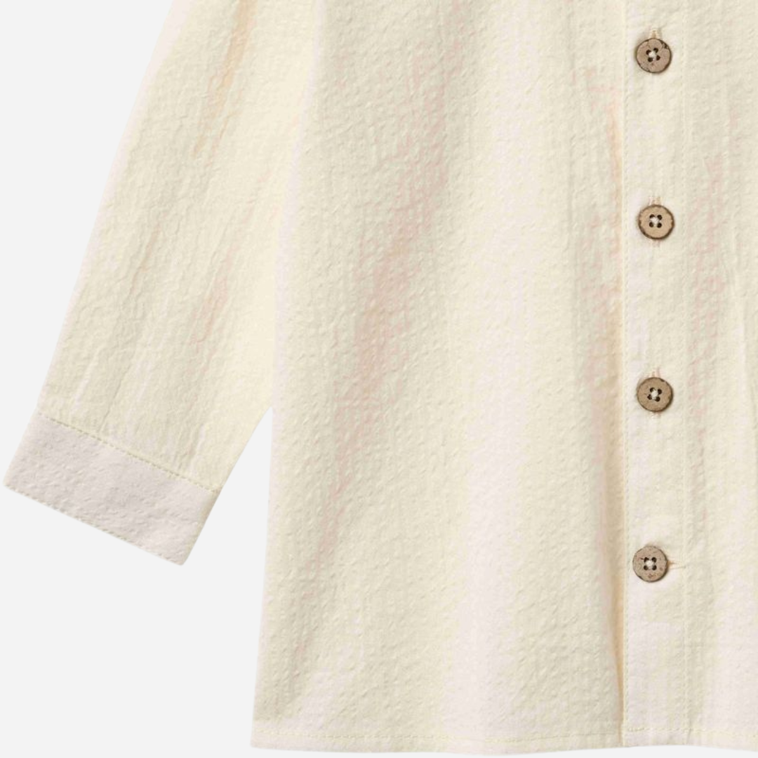 Sold at Bombon Shop, designed by Wheat, ivory organic cotton long sleeve button-down shirt with classic collar and clean silhouette.