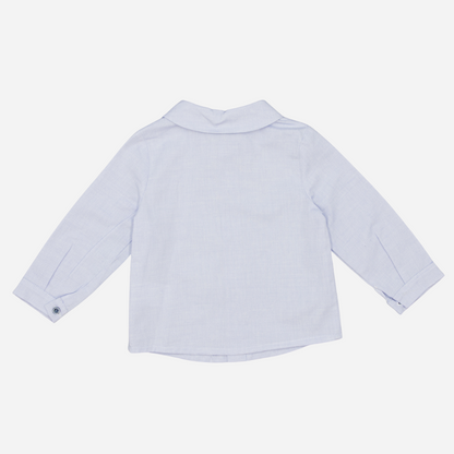 Sold at Bombon shop, designed by Fina Ejerique, a light-blue cotton baby shirt with rounded collar, long sleeves, and matching buttons back