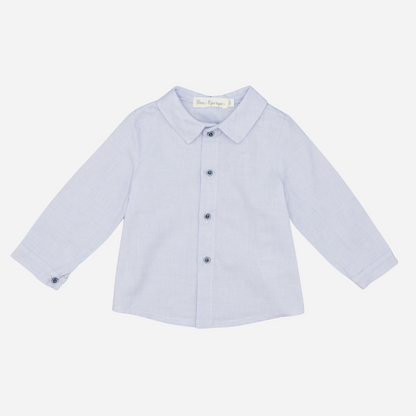 Sold at Bombon shop, designed by Fina Ejerique, a light-blue cotton baby shirt with rounded collar, long sleeves, and matching buttons. front