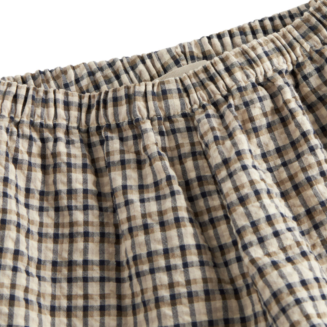 Sold at Bombon shop, designed by MarMar Copenhagen. Beige and navy check cotton pants with elastic waistband, pair perfectly with the matching beige shirt.