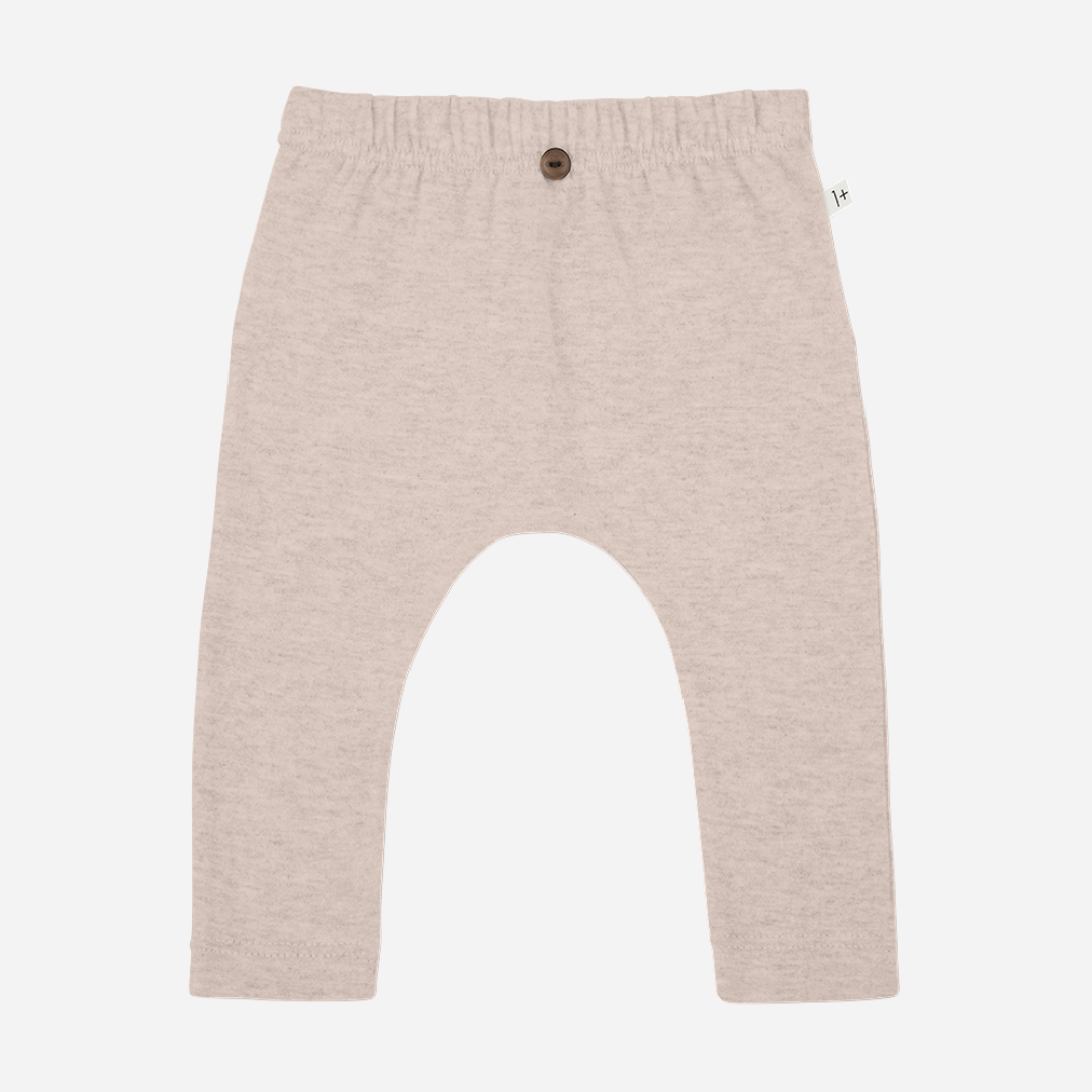 Sold at Bombon shop, designed by 1+ in the family — nude cotton baby leggings with elastic waistband and button detail, shown flat on white background.