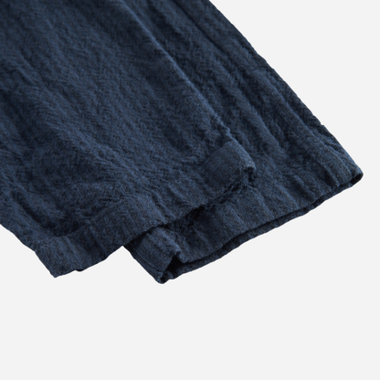 Sold at Bombon shop, designed by MarMar Copenhagen — navy 100% cotton textured baby pants with elastic waistband, part of a matching set.