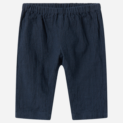 Sold at Bombon shop, designed by MarMar Copenhagen — navy 100% cotton textured baby pants with elastic waistband, part of a matching set.