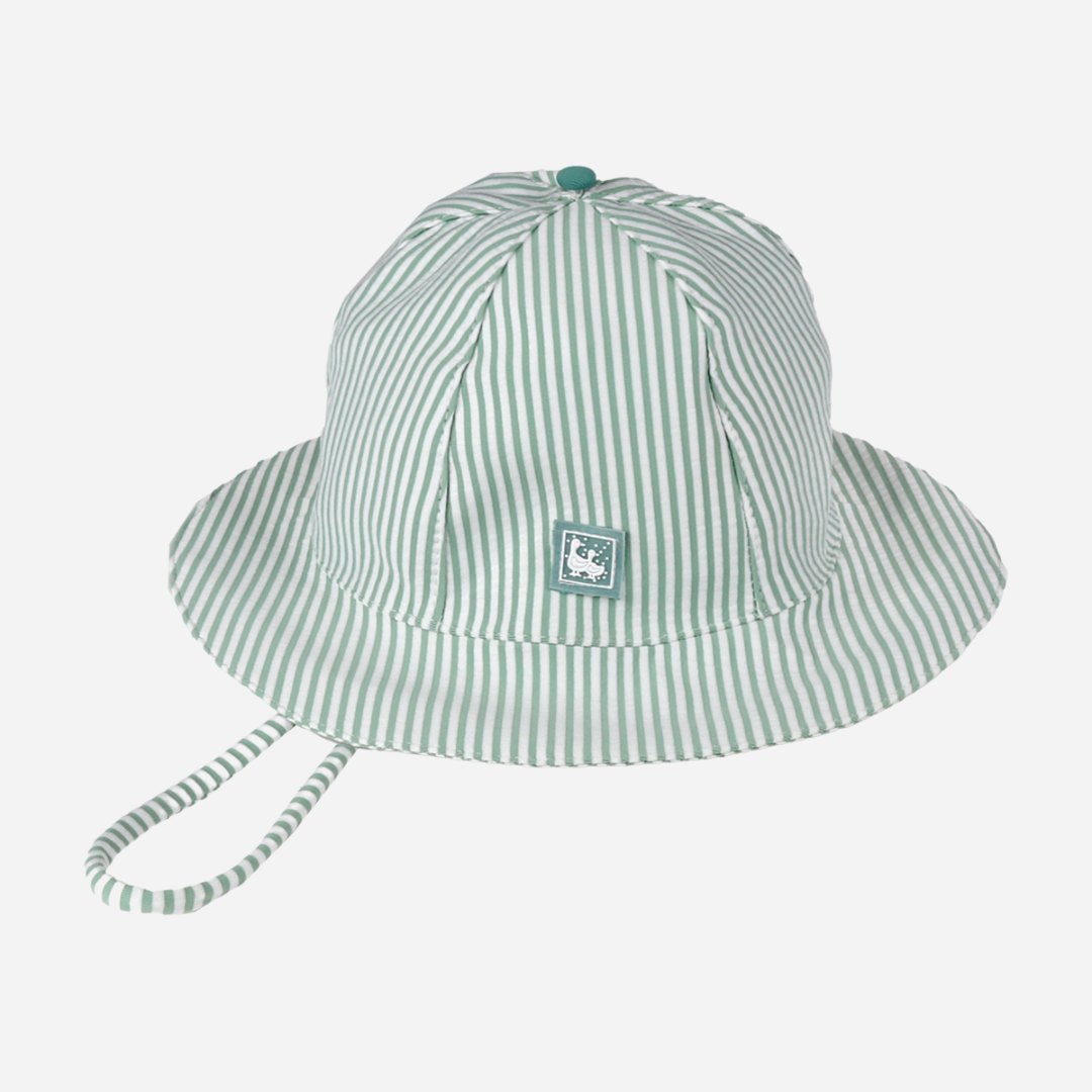 sold at Bombon shop, designed by Al Agua Patos Brand, this green and white striped baby hat provides sun coverage and is waterproof. Perfect for summer. front view