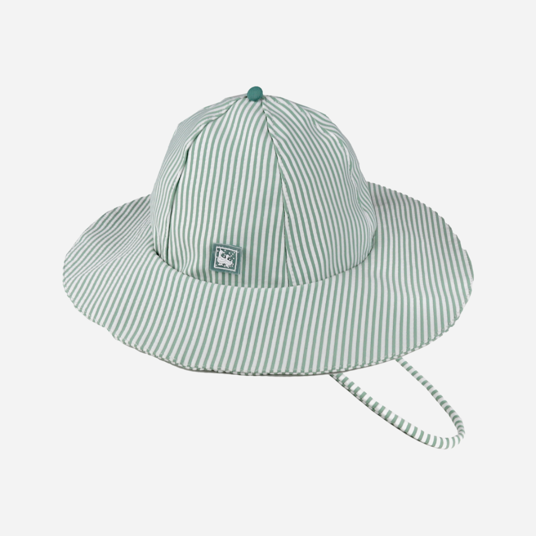 sold at Bombon shop, designed by Al Agua Patos Brand, this green and white striped hat provides sun coverage and is waterproof. Perfect for summer. front view