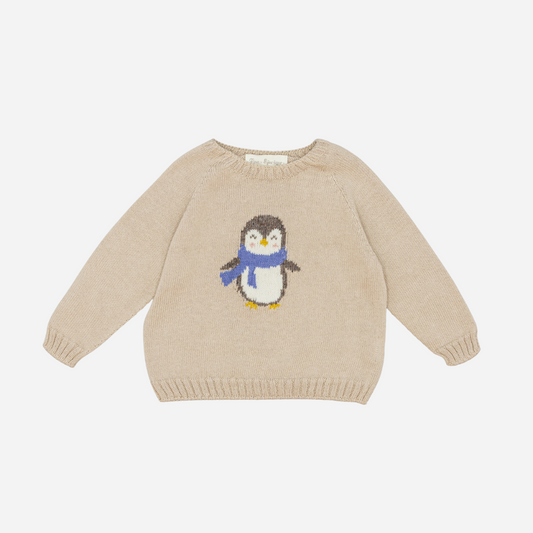 Sold at Bombon shop, designed by Fina Ejerique, a beige knit baby sweater with a penguin motif wearing a blue scarf. front