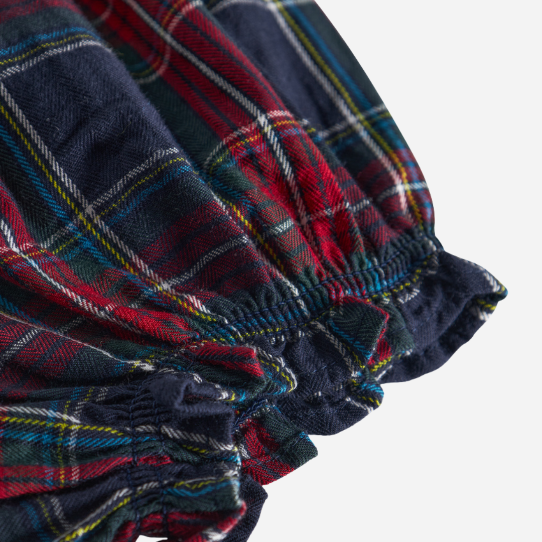 Sold at Bombon shop, designed by MarMar Copenhagen. Red and navy plaid baby bloomers with elastic waistband, pair perfectly with the embroidered collar bodysuit and matching red cardigan.