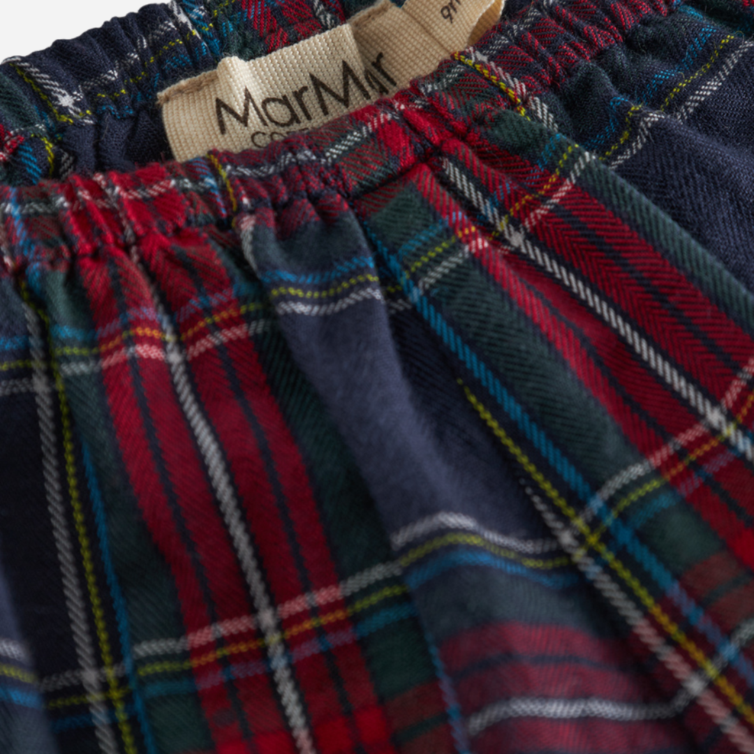 Sold at Bombon shop, designed by MarMar Copenhagen. Red and navy plaid baby bloomers with elastic waistband, pair perfectly with the embroidered collar bodysuit and matching red cardigan.