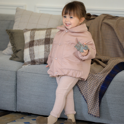 Sold at Bombon shop, designed by 1+ in the family — nude striped baby leggings with elastic waist and single button detail. model
