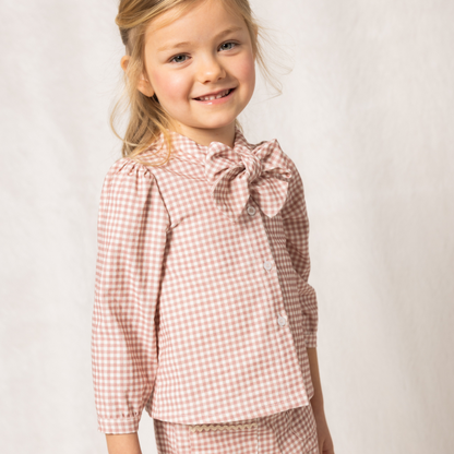 Sold at Bombon shop, designed by Fina Ejerique, pink gingham corduroy blouse with bow collar and puffed shoulders, styled to pair with the matching pants. model