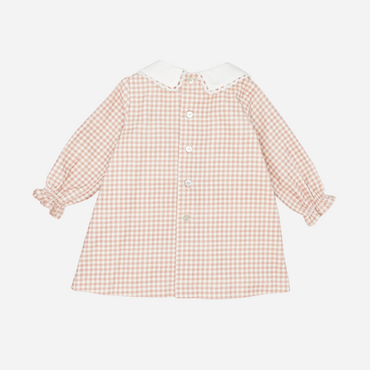 Sold at Bombon shop, designed by Fina Ejerique, a blush-pink gingham baby dress with white collar, lace trim, front pockets, and long sleeves. back