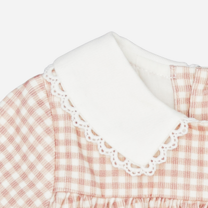 Sold at Bombon shop, designed by Fina Ejerique, a blush-pink gingham baby dress with white collar, lace trim, front pockets, and long sleeves. zoom