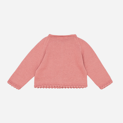 Sold at Bombon shop, designed by Fina Ejerique, a rose-pink knit baby cardigan with scalloped trim and front buttons. back