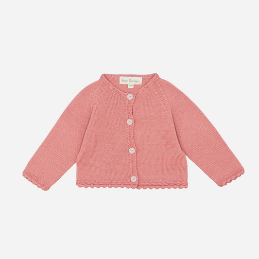 Sold at Bombon shop, designed by Fina Ejerique, a rose-pink knit baby cardigan with scalloped trim and front buttons. front