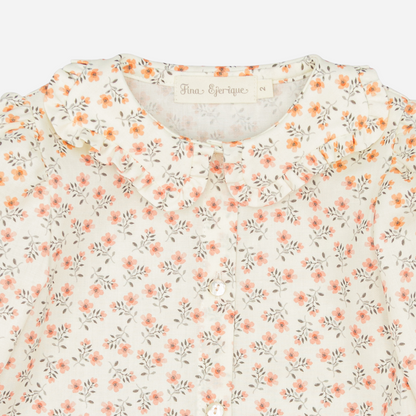 Sold at Bombon shop, designed by Fina Ejerique, floral viyella blouse with ruffled collar, pairs perfectly with the beige textured skirt and pink vest. zoom