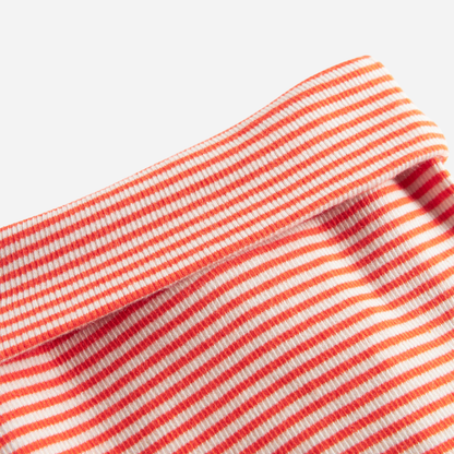 Sold at Bombon shop, designed by MarMar Copenhagen. Coral and cream striped baby footed pants, pair perfectly with the matching coral striped cardigan.
