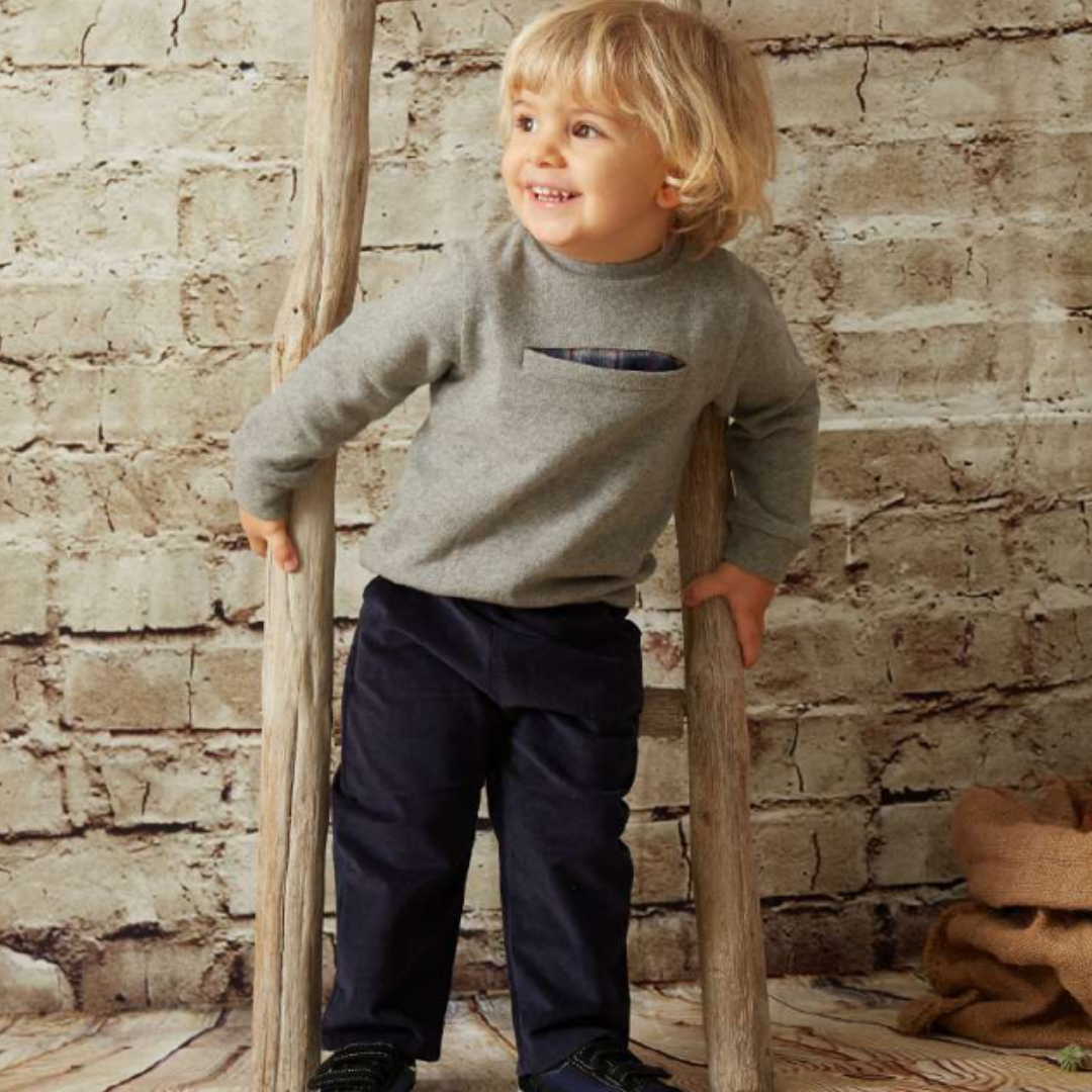 Sold at Bombon shop, designed by Tiny Soul — grey baby sweater with front slit pocket and hidden plaid lining. model