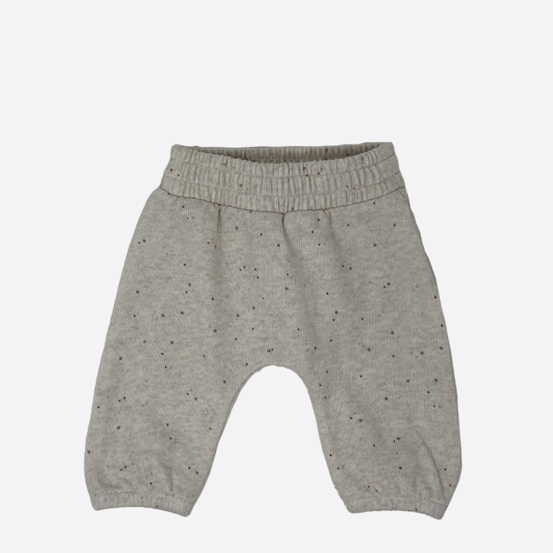 Sold at Bombon shop, designed by Tiny Soul — beige speckled knit baby pants with elastic waistband. front