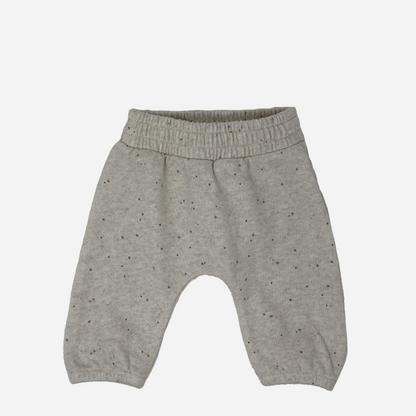 Sold at Bombon shop, designed by Tiny Soul — beige speckled knit baby pants with elastic waistband. front