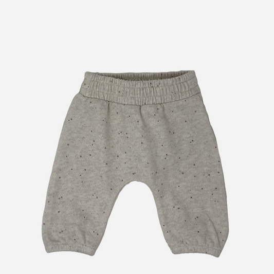 Sold at Bombon shop, designed by Tiny Soul — beige speckled knit baby pants with elastic waistband. front