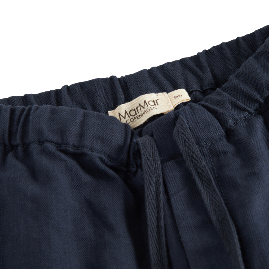Sold at Bombon shop, designed by MarMar Copenhagen. Navy cotton pants with drawstring waist, pair perfectly with the matching red check shirt.